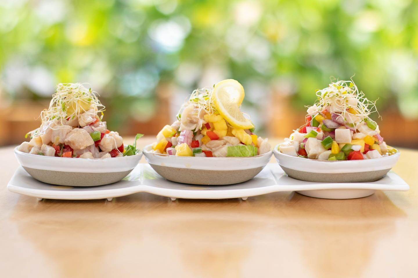 Three ceviche plates on a table