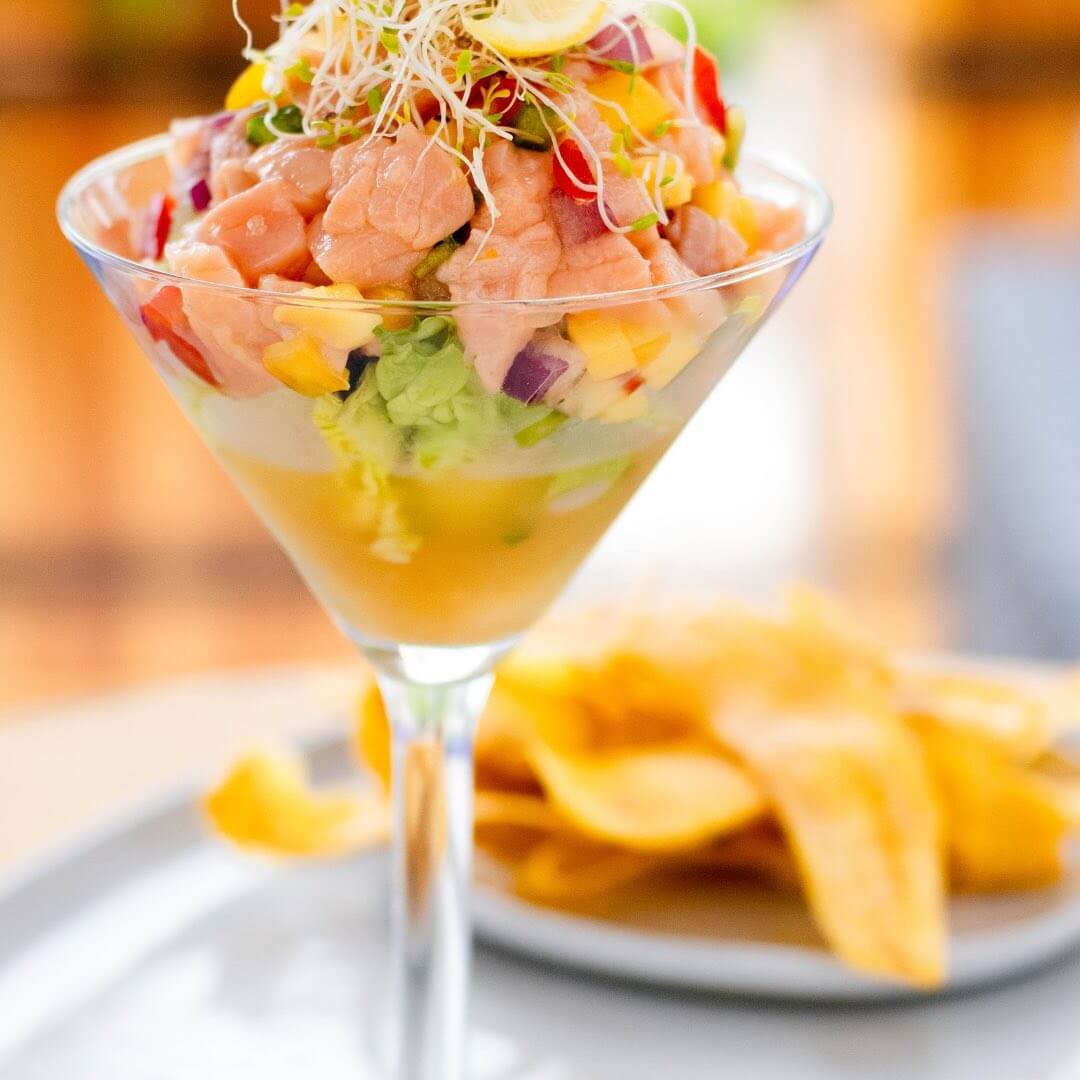 Ceviche served in a martini glass with chips