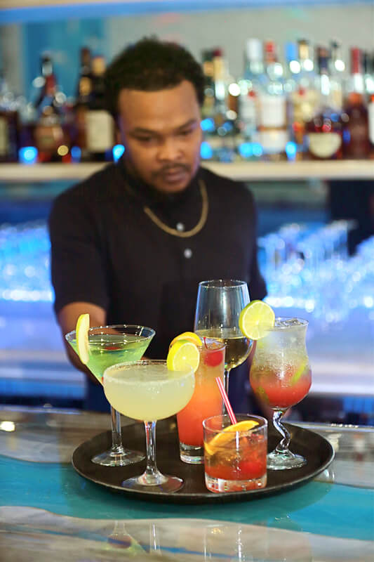 Bartender serving a tropical cocktail