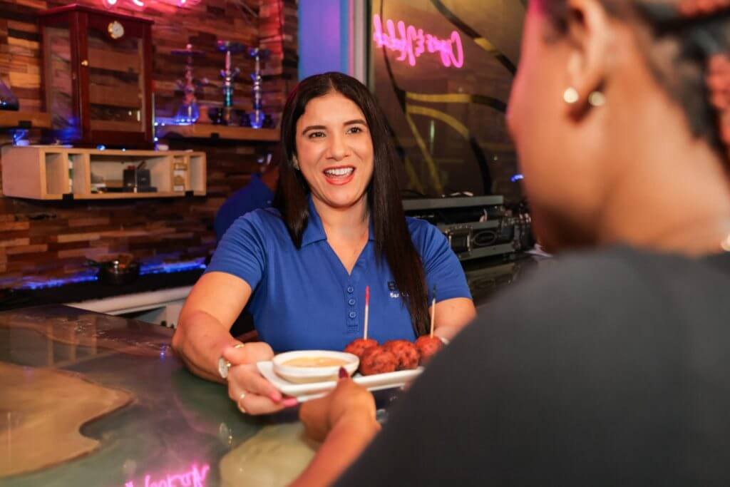 Bartender chatting with a guest at the bar